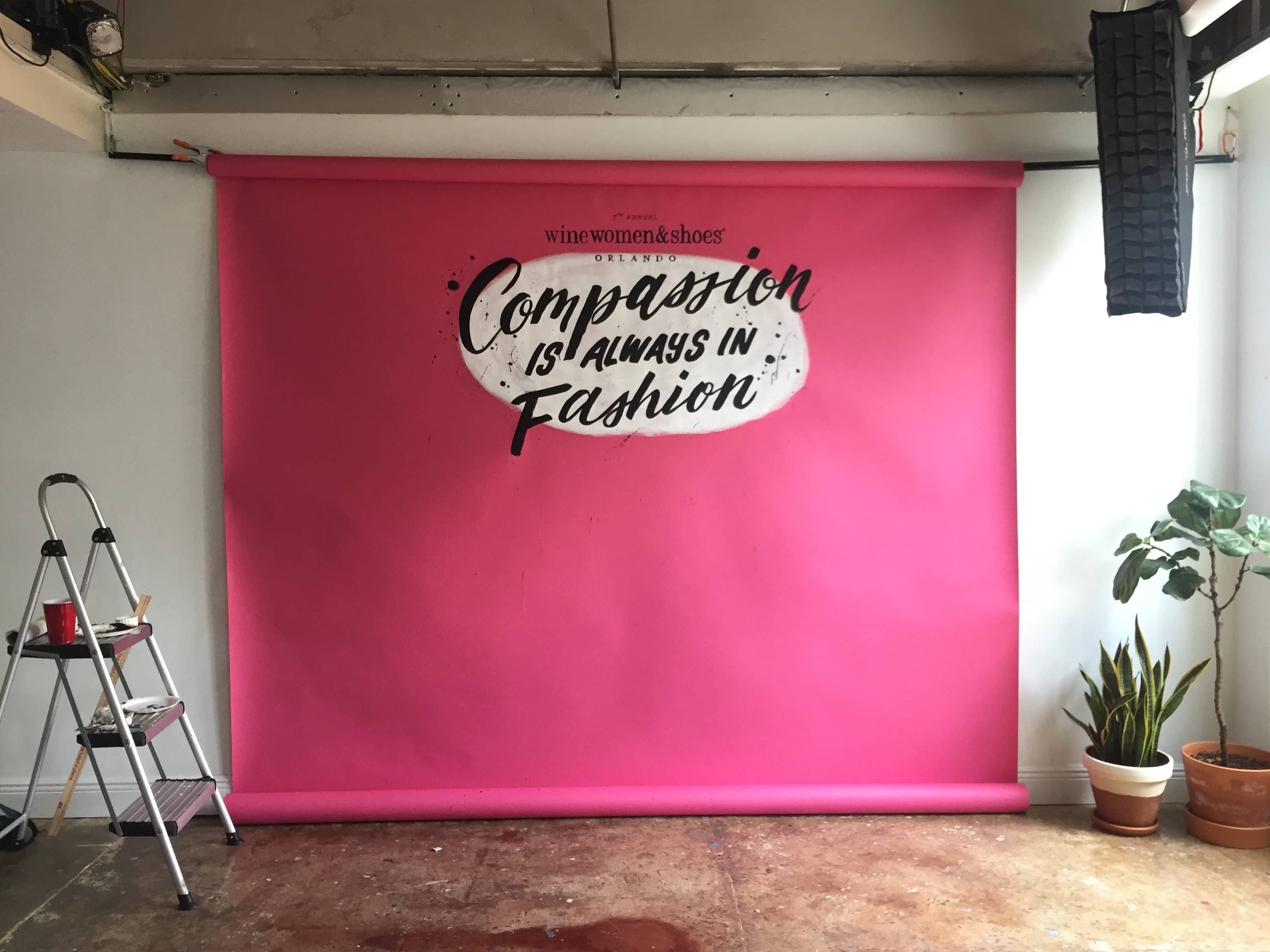 Compassion is Always in Fashion hand lettered backdrop for Wine Women and Shoes Orlando
